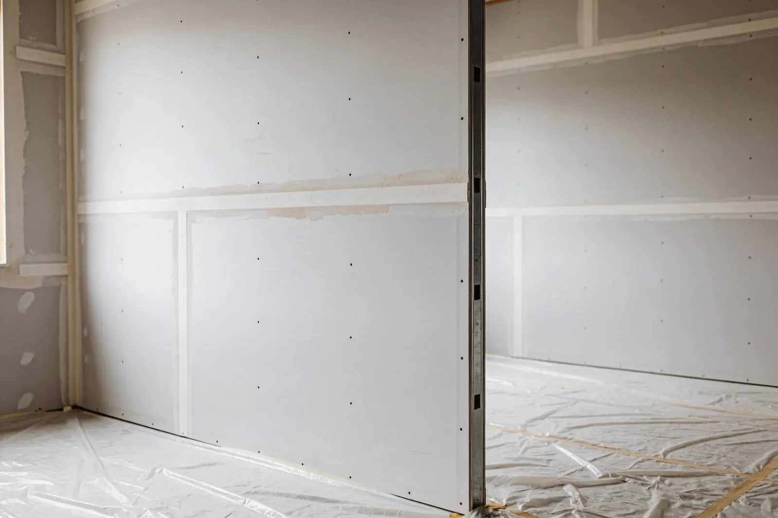 Cloison en plaques de plâtre finie, joints enduits et poncés
